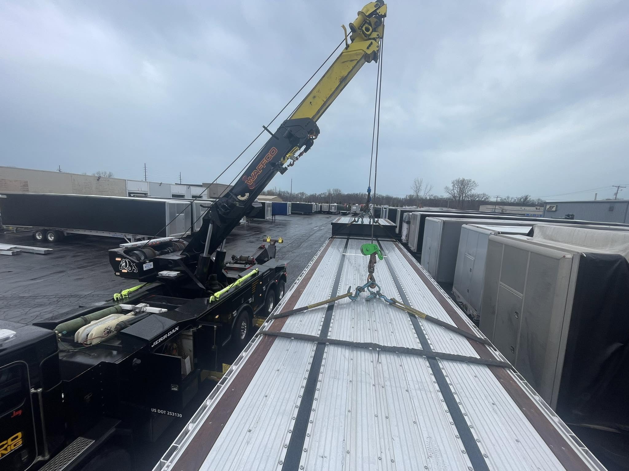 Rotator crane lifting freight from a trailer