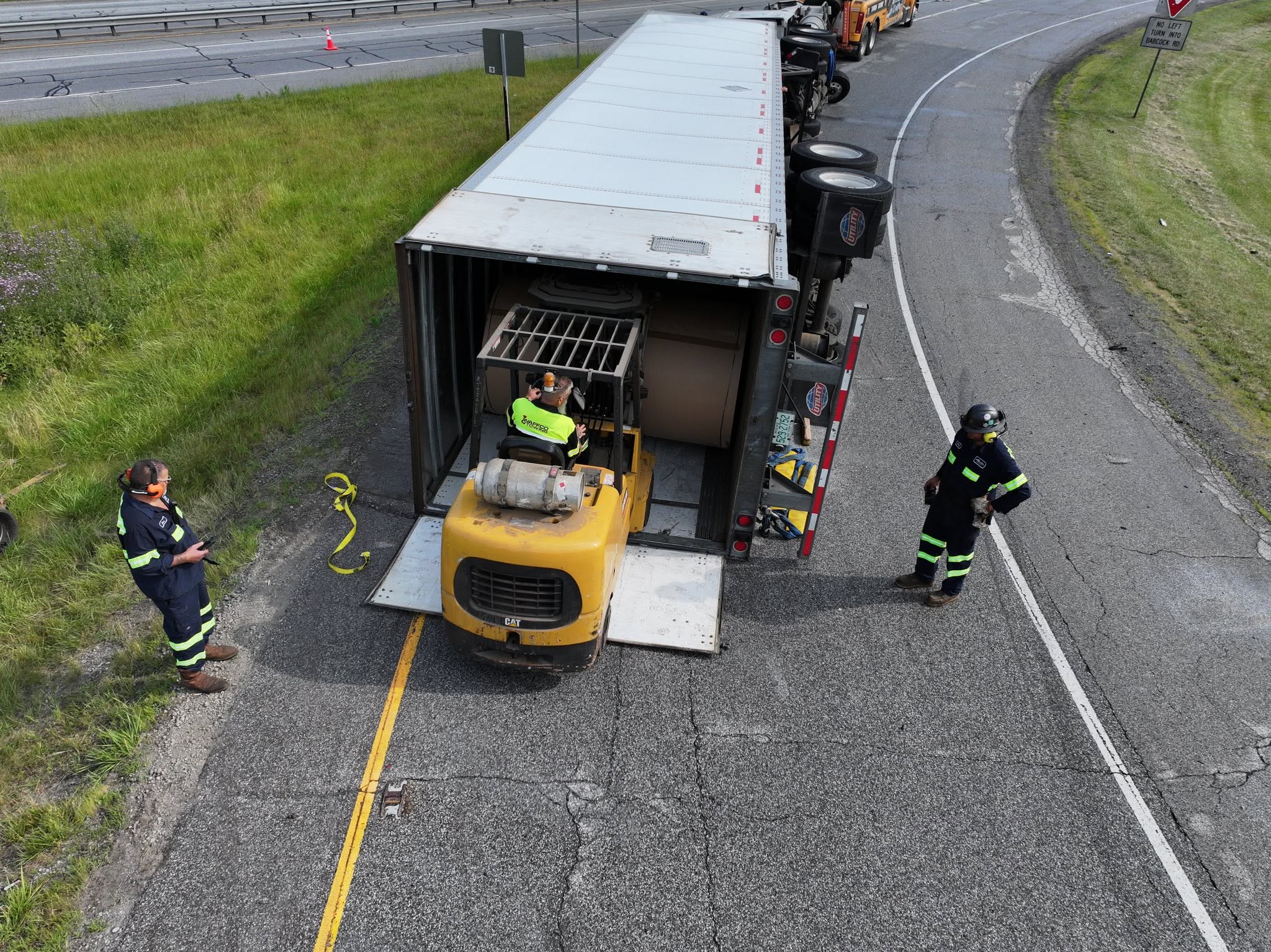 Forklift unloading freight from an overturned trailer