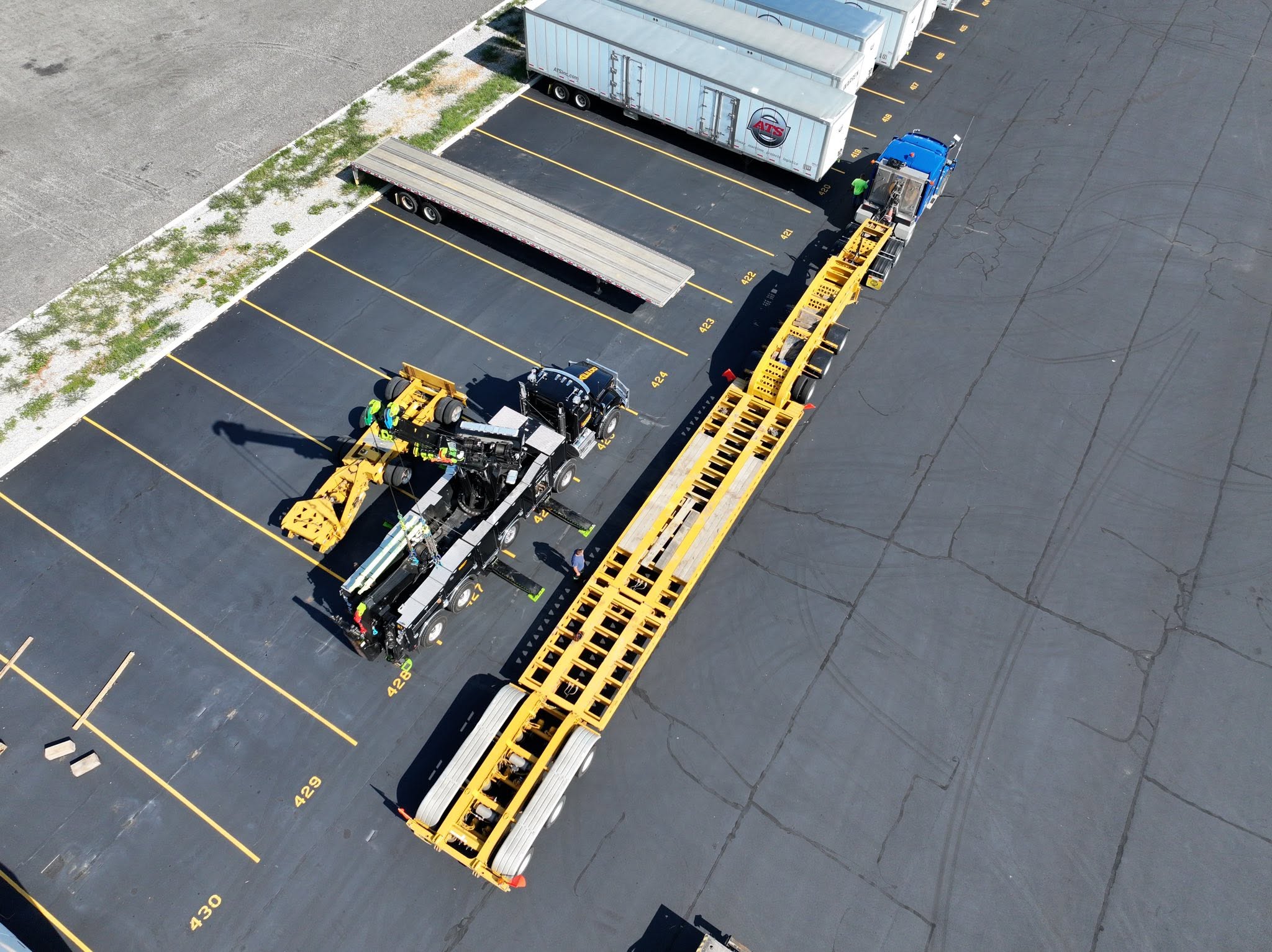 Rotator and RGN trailer handling heavy equipment