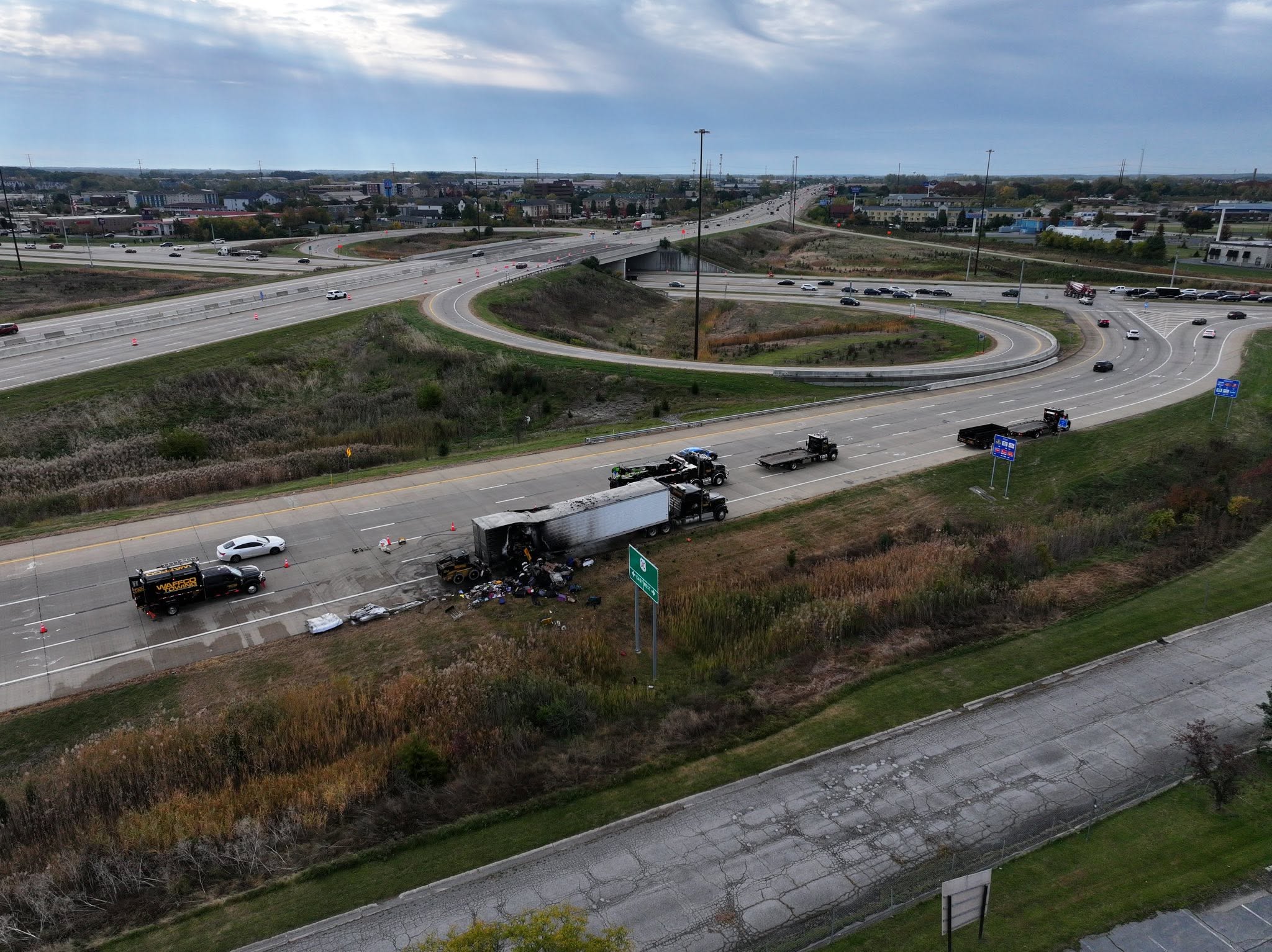 Aerial view of burned trailer recovery on a highway