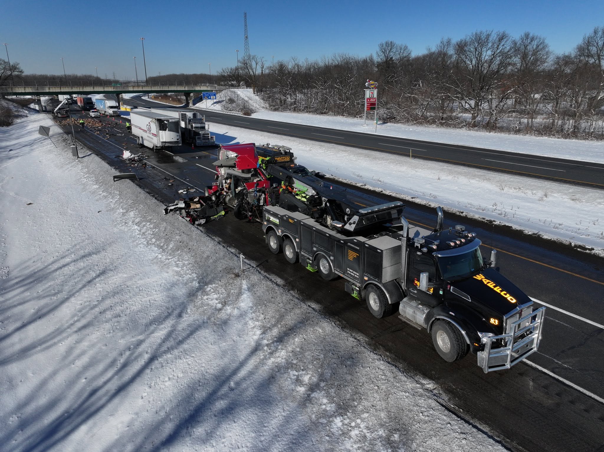 Winter semi recovery with a Waffco rotator on a snowy highway