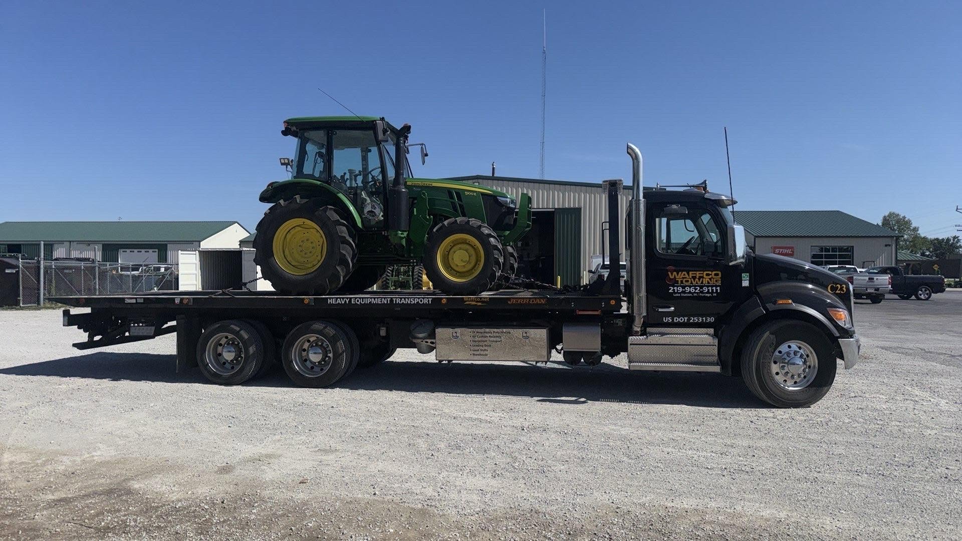 Waffco industrial carrier transporting a tractor