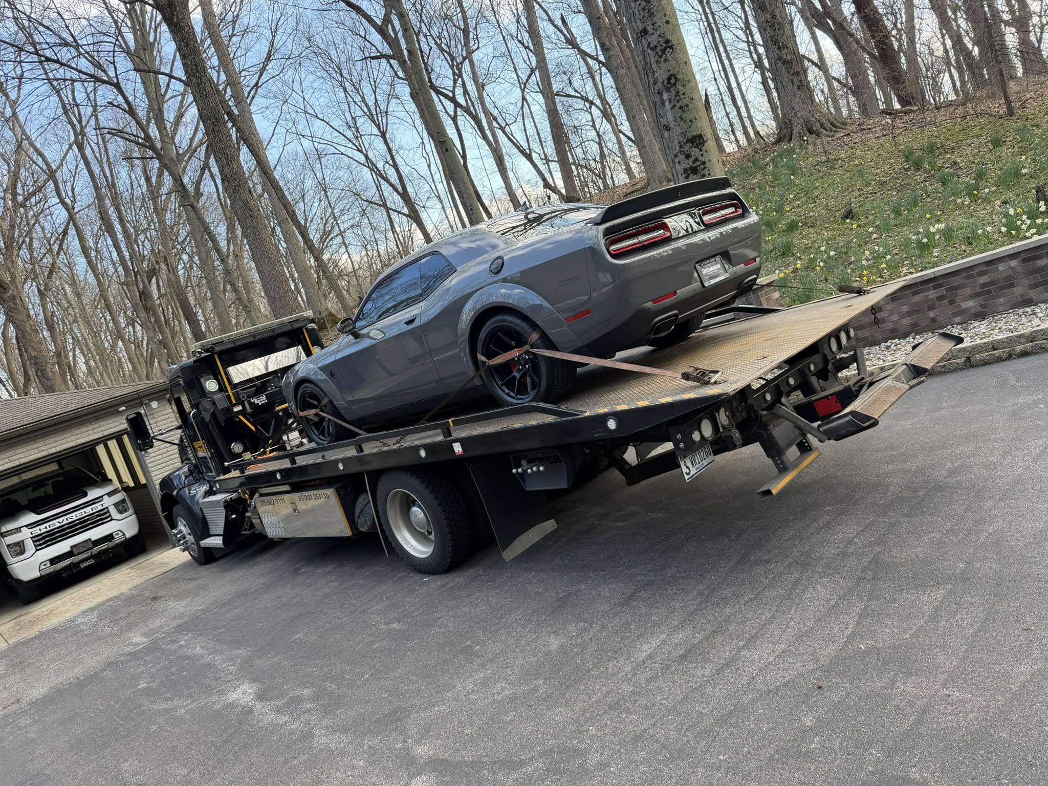 Specialty car loaded on a Waffco rollback